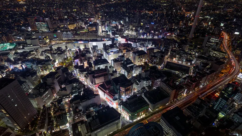 Ikebukuro, Tokyo, at night seen from high above, with lit streets, buildings and an elevated expressway