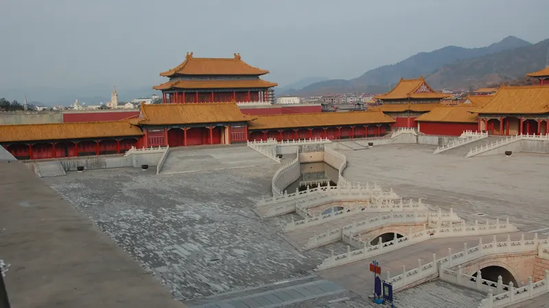 A replica imperial palace with golden roofs and marble bridges at Hengdian World Studios, a major Chinese drama filming base