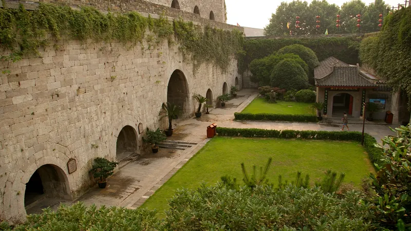 The massive Ming-era brick walls and arched vaults of Zhonghua Gate in Nanjing, with a walled garden courtyard below