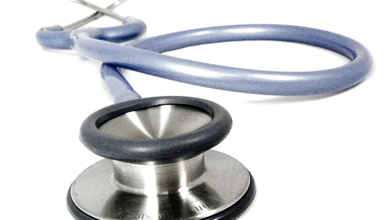 A doctor's stethoscope with blue tubing and a steel chest piece on a white background